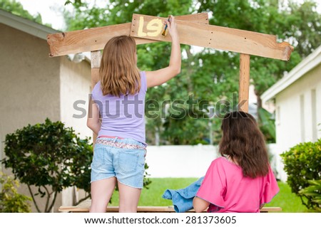 Young girls painting lemonade stand