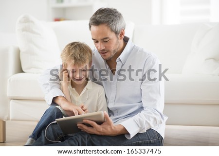 Father And Son Sharing Music Headphones