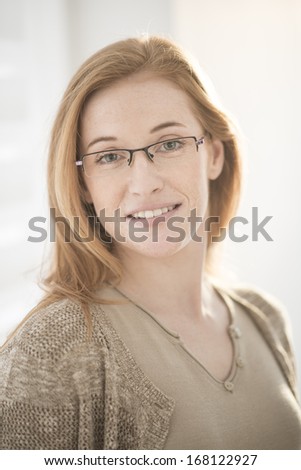 beautiful smiling redhead  woman with glasses