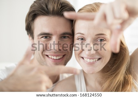 couple portrait forming a frame with their hands
