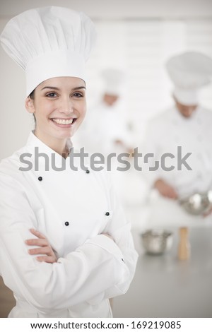kitchen team at work female chef at foreground
