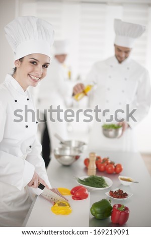 kitchen team at work female chef at foreground