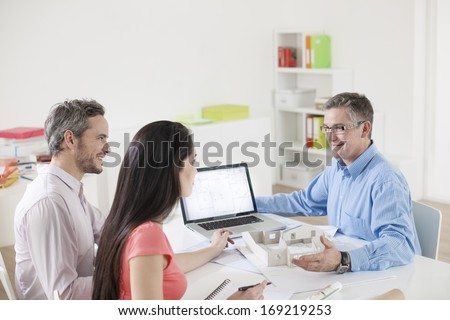 Young couple meeting construction planner