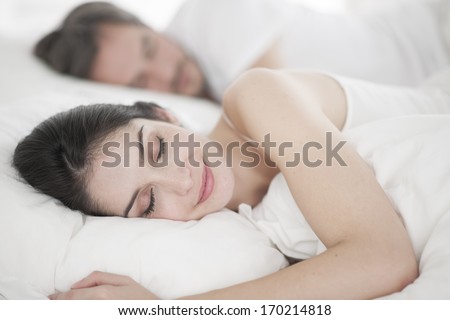 Romantic young couple sleeping in bed