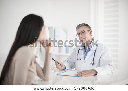 senior  doctor consulting female patient