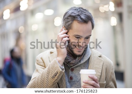 portrait of handsome man at phone  city lights in the background