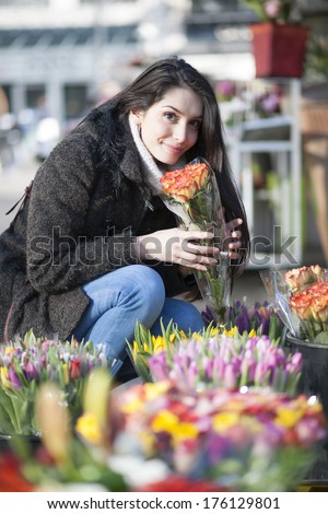 beautiful woman choosing flowers at the florist shop