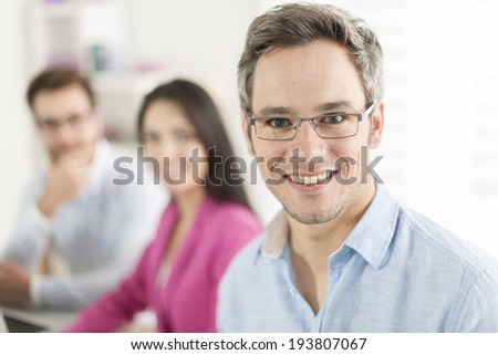 Portrait of a smiling senior businessman  in meeting
