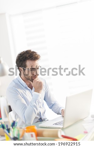 modern businessman working on his laptop at office