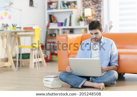 young student works on his laptop at home