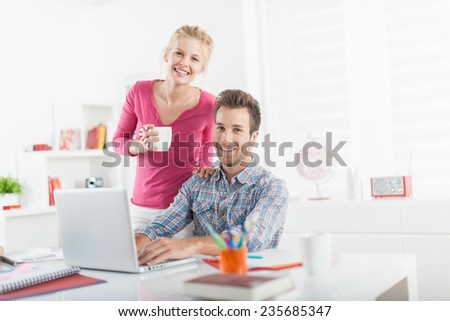modern young couple at home purchasing on-line on a computer