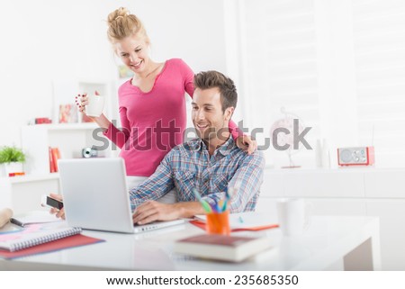 modern young couple at home purchasing online on a computer