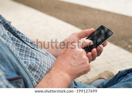 hands of an elderly man holding phone