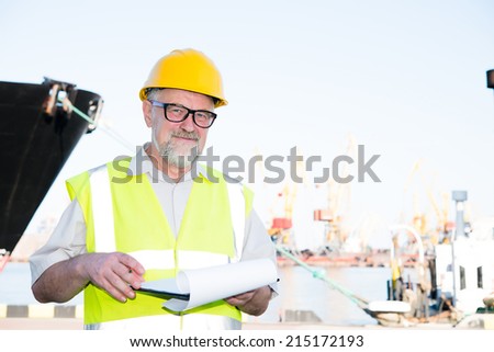 a man in a helmet in the port makes entries in the securities