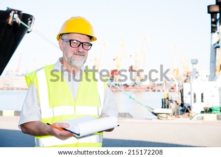 a man in a helmet in the port makes entries in the securities