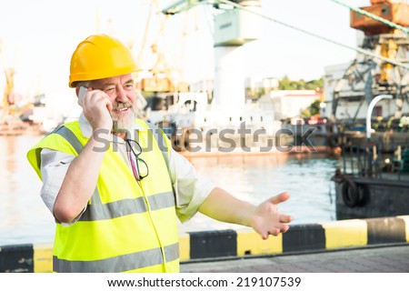 a man in a helmet speaks on the phone port