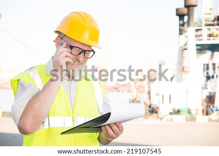 a man in a helmet speaks on the phone port