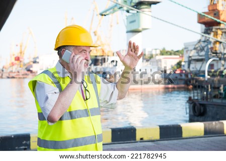 a man in a helmet speaks on the phone