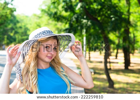 beautiful young woman in hat park