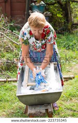 grandmother wash clothes in a tub hands