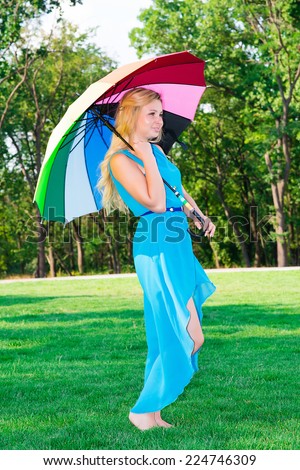 beautiful young woman with an umbrella rainbow