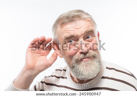 Closeup portrait, senior man, grandfather hard of hearing, placing hand on ear asking someone to speak up, isolated white background. Negative emotion, facial expressions, feelings, reaction, aging