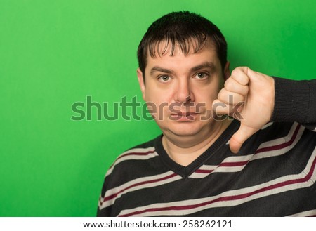 man sign your <b>finger down</b> on a green background - stock-photo-man-sign-your-finger-down-on-a-green-background-258262121