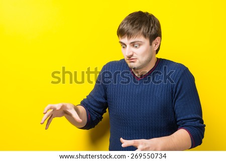 Young Man Holding His Hands Out In Fear