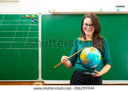 Teacher holding globe in hand