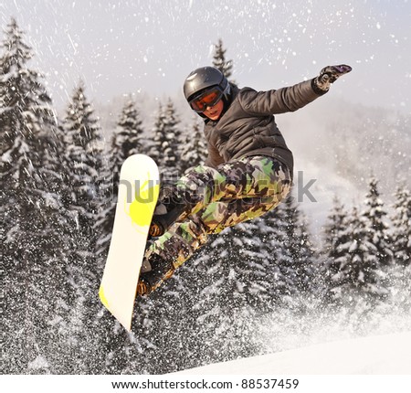 Snowboarder jumping through