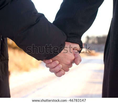 Romance - Old couple holding hands together out for a walk