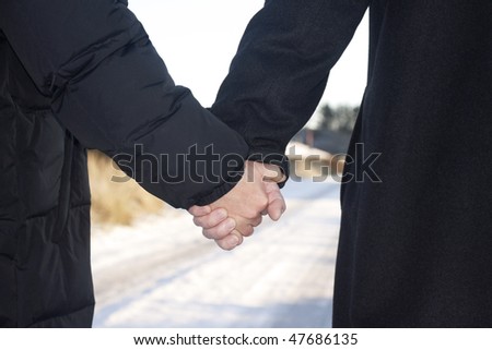 Love - older couple holding hands  taking a walk outside