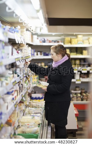 Shopping - Beautiful woman looking different items in store