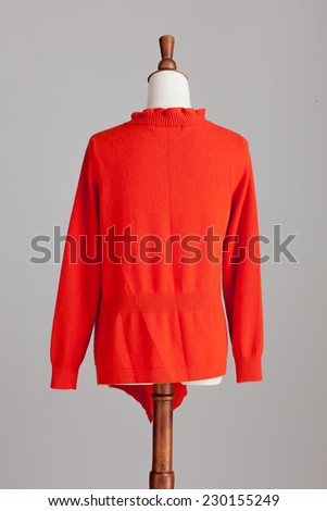 red woman cashmere sweater with wood model on grey isolated