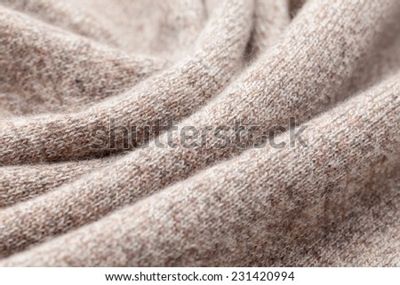 Detail of woven woolen design texture. Fabric brown background