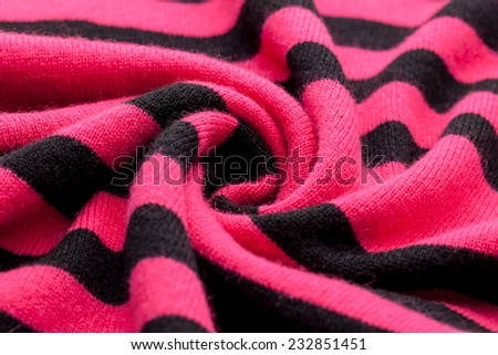 Detail of woven woolen design texture. Fabric pink and black  background