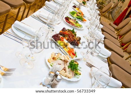 Banquet. Table with food. Glasses, plates and forks.