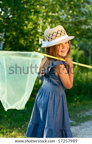 Happy beautiful girl with butterfly net at the sunshine.