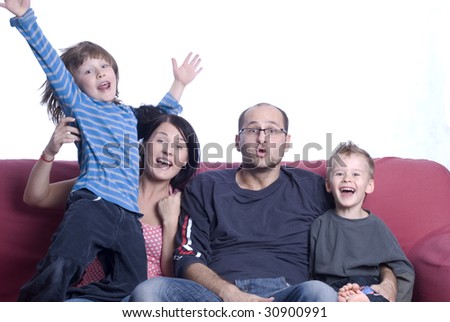 Happy young family on couch sitting
