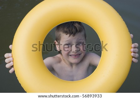 smiling boy in ring-buoy