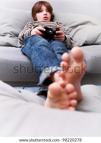 Young boy with joystick playing computer game