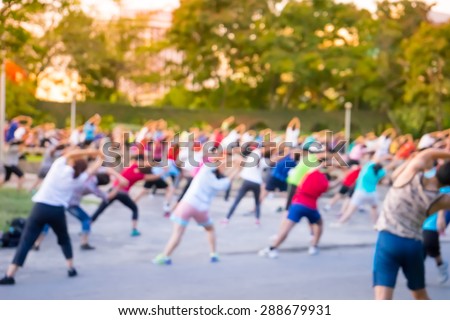 Blur background group man and women  dancing a fitness dance or aerobics in an old park