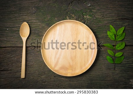 wood dish spoon and leaves on old wood table. Concept How to lose weight still-lift