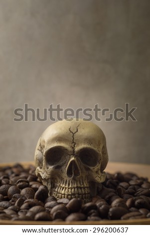 skulls and coffee bean on old wood table copy space vintage style. Concept Dangers of Drinking Coffee still life