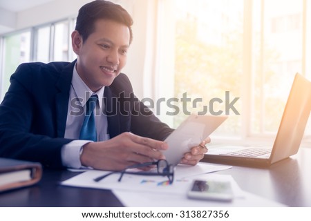 asian business executive working in office.