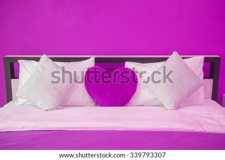 Simple purple bedroom with bed and nightstand.copy space