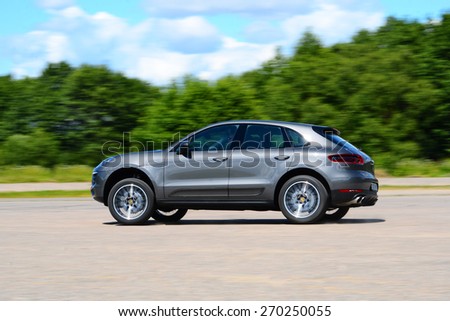 MINSK - JUNE 2014: Porshe Macan S drives along the road during the test drive event for automotive journalists from Minsk