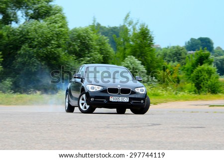 MINSK - JULY 2015: new BMW 1-series 2015 drives along the road during the test drive event for automotive journalists from Minsk
