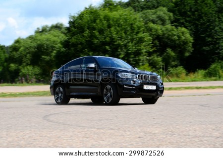 MINSK - JULY 2015: BMW X6 M50d drives at the test drive event for automotive journalists from Minsk