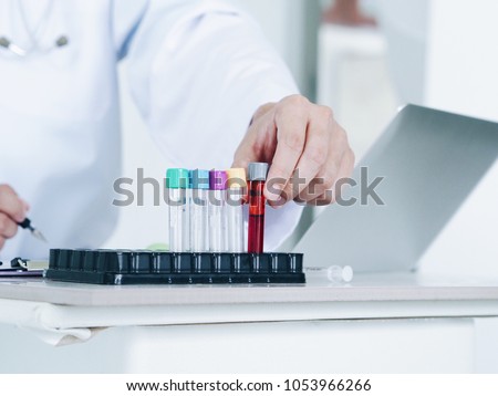 Close up doctor hands With blood testing.